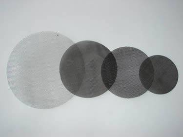Four single layered filter discs of different sizes.