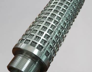 A pleated candle filter with a perforated layer.